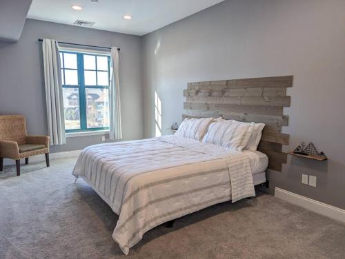 a bedroom with a large bed and a chair at 2 Bed Top Flr Prem Penthouse Suite in Vernon Township