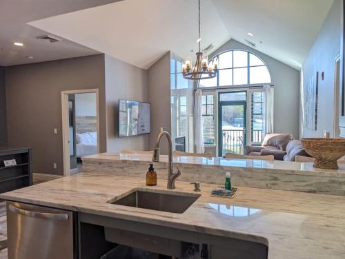 a kitchen with a sink and a living room at 2 Bed Top Flr Prem Penthouse Suite in Vernon Township