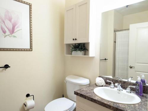 a bathroom with a white toilet and a sink at Spacious 3 bed 2 bath Sanctuary in Vernon Township
