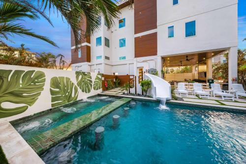 a swimming pool in front of a building at Top Deck Estate in Siesta Key