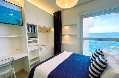 a bedroom with a bed and a large window at Casa Pomonte in Pomonte