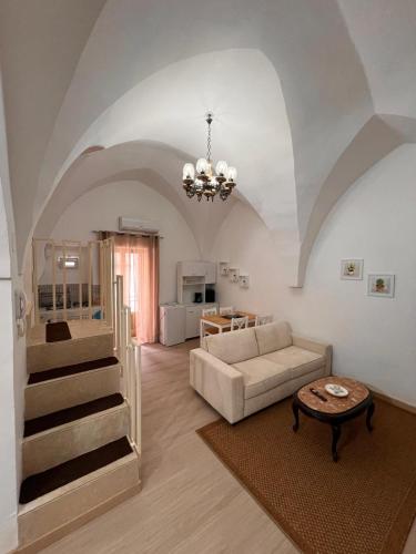 a living room with a couch and a table at Casa Vacanza Pietre & Cielo in Ceglie Messapica