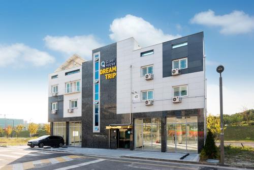 a building with a car parked in front of it at DreamTrip Guesthouse in Incheon