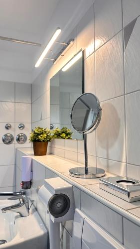 a bathroom with a mirror and a sink at AMAO-Sienna - Walk to Europa-Park - Terrace - 6 Guests in Rust