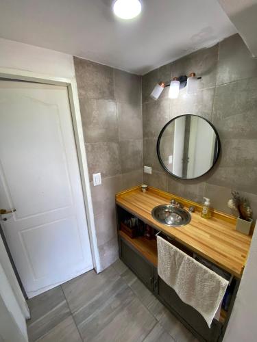 a bathroom with a sink and a mirror at HastaLaRaíz-LosReartes in Los Reartes