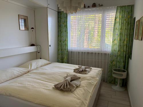 a bedroom with a bed with bows on it at Ferienwohnung C15 in Orselina