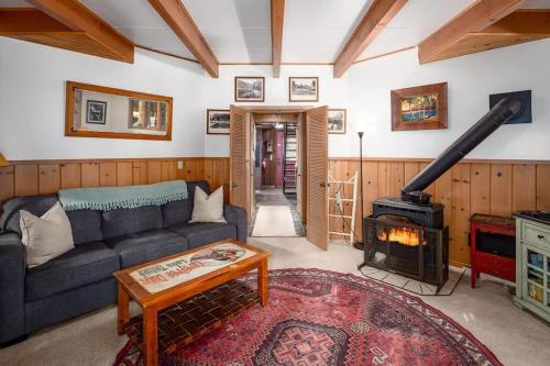 a living room with a couch and a wood stove at The Gingerbread Cottage in Kings Beach