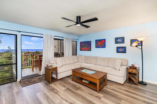 a living room with a couch and a ceiling fan at Sea Village 2106 in Kailua-Kona
