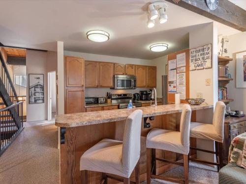 a kitchen with a large island with bar stools at Bear's Den in Kings Beach