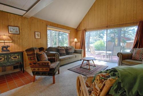 a living room with a couch and chairs and a fireplace at McCarthy Place in Tahoe Vista