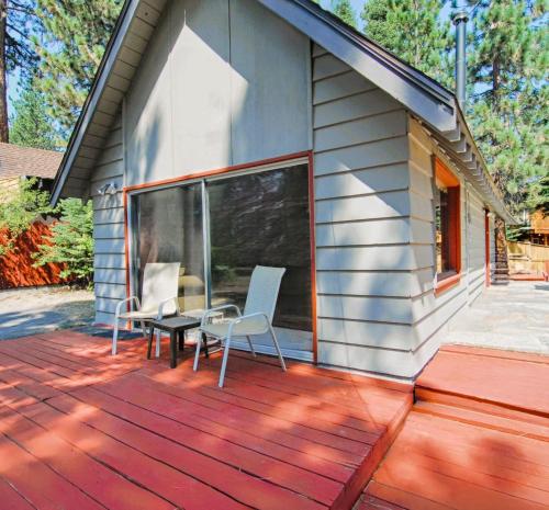 a deck with two chairs and a table on a house at McCarthy Place in Tahoe Vista