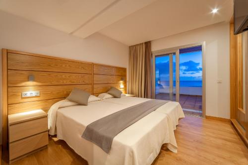 a bedroom with a large bed with a view of the ocean at Hotel Lancelot in Arrecife