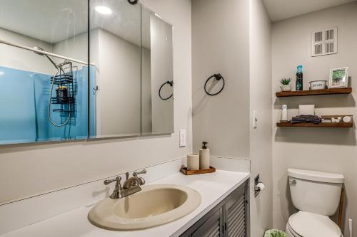 a bathroom with a sink and a toilet at Riverfront Cabin w/ Hot Tub in Schroon Lake! in Schroon Lake
