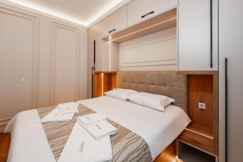 a bedroom with a bed with two towels on it at Central Premium Suites in Plovdiv