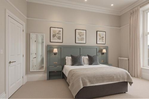a bedroom with a large bed with two pillows at The Highfield - Self Check-in Hotel in Keswick