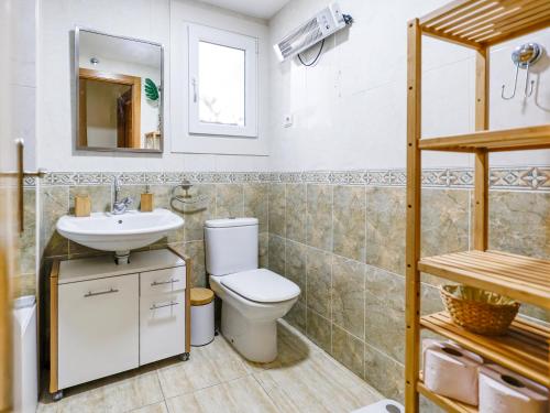 a bathroom with a toilet and a sink at Playa Oliva Apartment in Playa