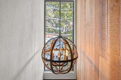 a hanging basket chandelier in front of a window at Corwin's Quarters in Kings Beach