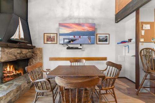 a dining room with a table and a fireplace at Corwin's Quarters in Kings Beach