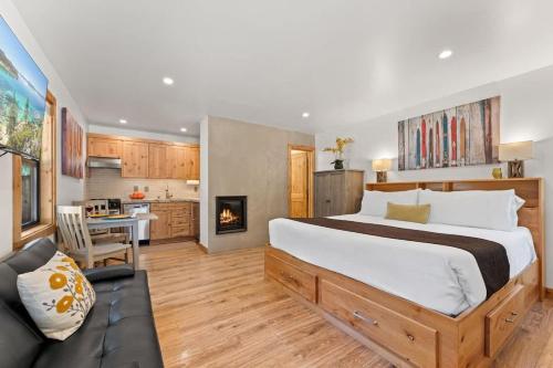 a bedroom with a large bed and a kitchen at Bearfoot Bungalow in Tahoe Vista
