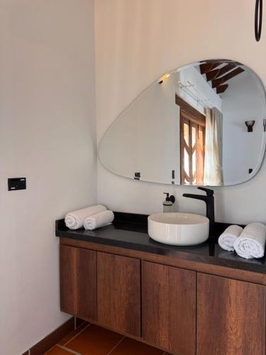 a bathroom with a sink and a mirror at Hotel Cala in Cucaita