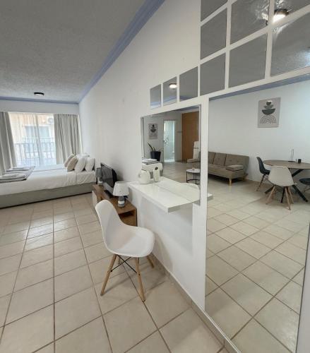 a living room with a couch and a table and a kitchen at Basilica Holiday Resort Apts in Paphos
