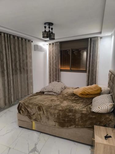 a bedroom with a large bed in a room at Appartement nador G in Nador