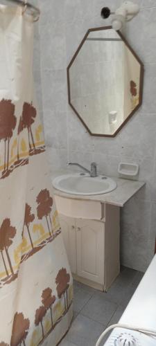 a bathroom with a sink and a mirror at El Legado in San Pedro