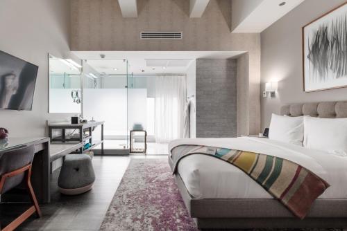 a hotel room with a bed and a desk and a bedroom at Stanton House El Paso in El Paso
