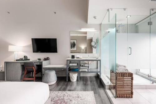 a living room with a desk and a television in a room at Stanton House El Paso in El Paso