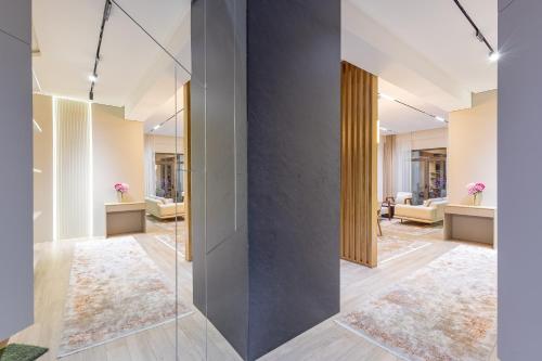 a hallway with a glass wall in a house at Luxury 98m2, City Boulevard View, Fountain View, Tashkent City in Tashkent