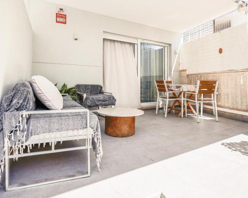 a living room with a couch and a table at Playa Oliva Apartment in Playa