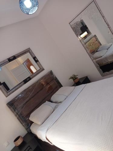 a bedroom with a bed and a mirror on the wall at Villa Catalpas in Taroudant