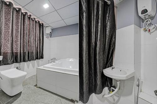 a bathroom with a sink and a toilet and a bath tub at The Bull Group International in Surat