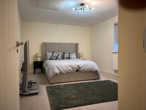a bedroom with a bed and a television in it at Haven at Chafford Hundred in West Thurrock