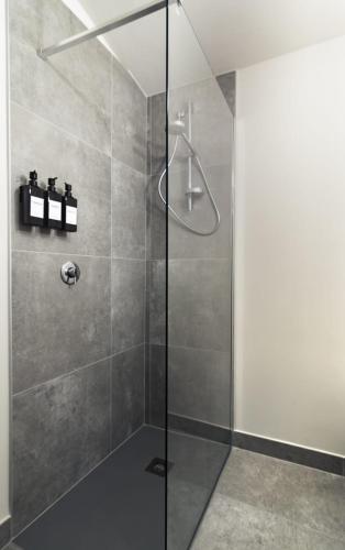 a shower with a glass door in a bathroom at Il Ninfeo in Volta Mantovana