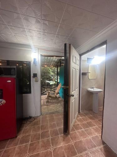 a bathroom with a red refrigerator and a sink at Villa Luis in Boquete