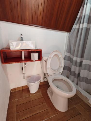 a bathroom with a toilet and a sink at Cabañas Martina Surf Playa Guanico in Pedregal