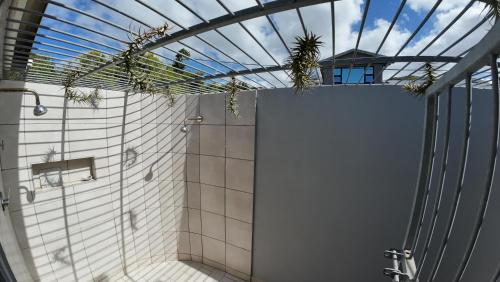 a bathroom with a shower and a glass ceiling at Ebb & Flow Beach House in Oyster Bay