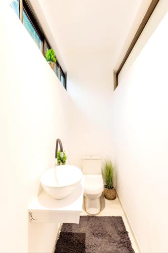 a bathroom with a sink and a toilet at Aion Suites 301 in North Legon