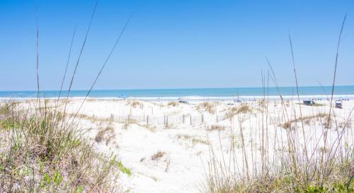 a beach with sand and the ocean in the background at The Beach Club St Augustine by Coolvacay in Saint Augustine Beach