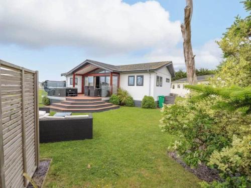 a home with a yard with a house at Honeysuckle lodge in Abergele
