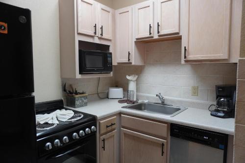 a small kitchen with a sink and a stove at River Place Condos Riverside #209 in Pigeon Forge