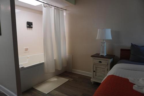a bedroom with a bed and a window with a lamp at River Place Condos Riverside #209 in Pigeon Forge