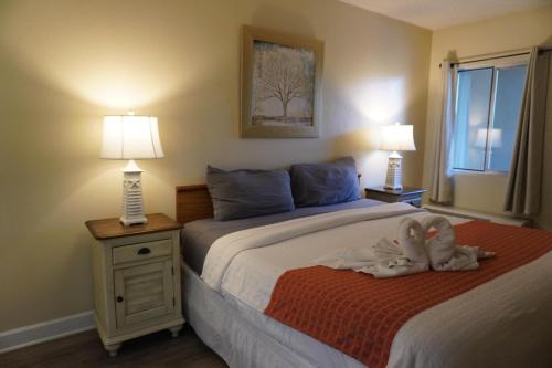 a bedroom with a bed with a stuffed animal on it at River Place Condos Riverside #209 in Pigeon Forge