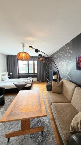a living room with a couch and a table at Fjordhotellet in Lysekil