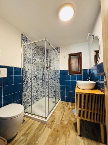 a bathroom with a shower and a toilet and a sink at Lemontree House Bacoli in Bacoli