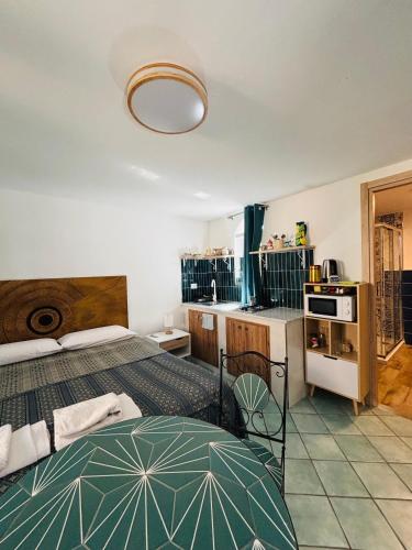 a bedroom with a bed and a small kitchen at Lemontree House Bacoli in Bacoli