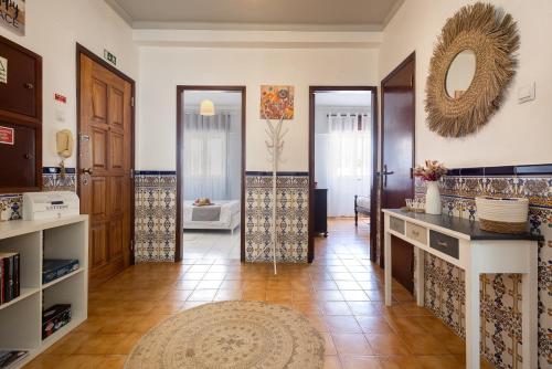 a living room with a counter and a mirror at AL Bela Vida in Tavira