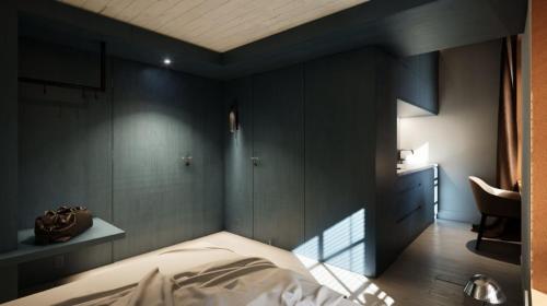 ein Schlafzimmer mit schwarzen Wänden, einem Bett und einem Stuhl in der Unterkunft Schiffli - Boutique Apartments - Self Check In in Rapperswil-Jona