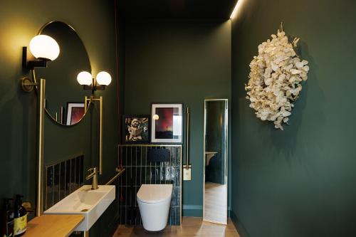 a bathroom with two sinks and a large chandelier at Barnahown B&B, Mitchelstown in Mitchelstown